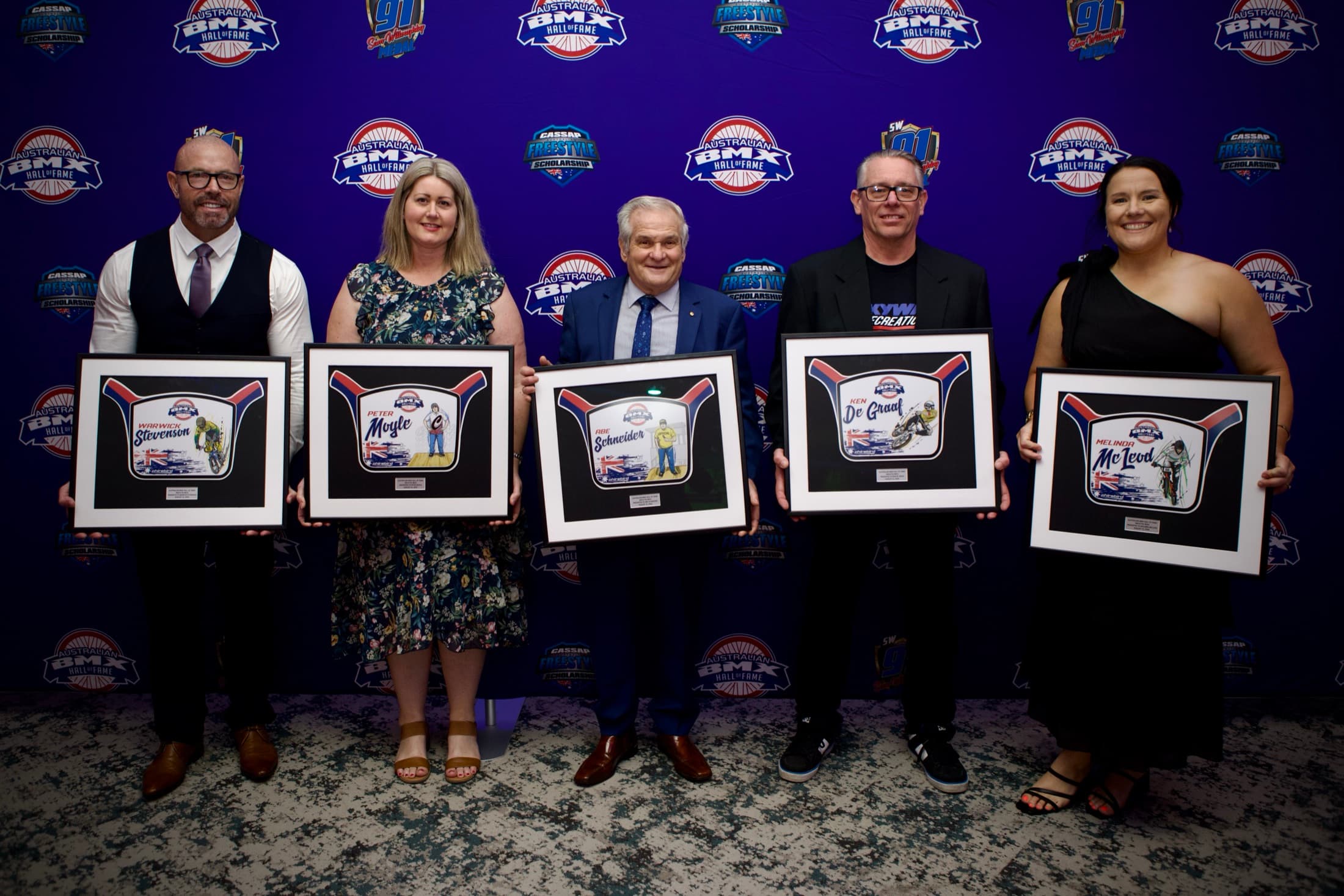 The 2026 Australian BMX Hall Of Fame inductees holding their framed induction plates.